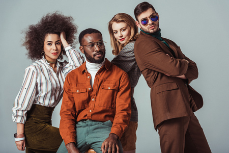 multicultural retro styled friends posing isolated on greyの写真素材