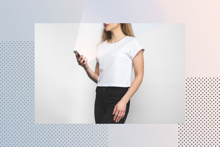 cropped shot of woman in blank t-shirt on white with creative frameの写真素材