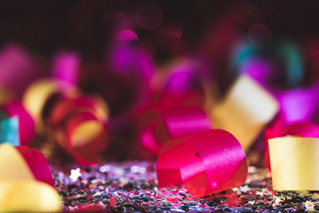 colorful christmas confetti and shiny stars with blurred backgroundの写真素材