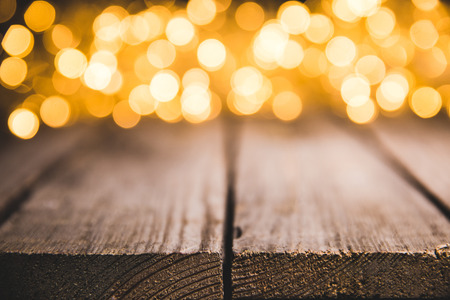 festive blurred lights on wooden surface, christmas backgroundの写真素材
