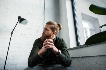 bottom view of businessman sitting and looking up