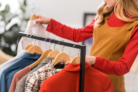 cropped view of fashion designer working with clothes in modern officeの写真素材