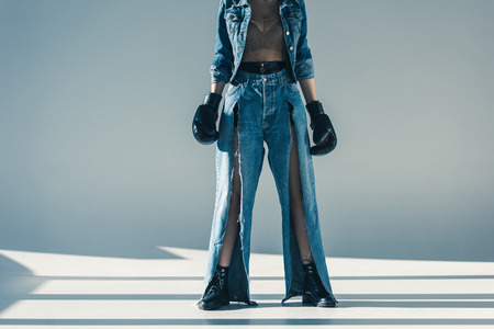 cropped view of woman in denim clothes with boxing glovesの写真素材
