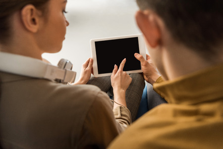 close-up shot of young couple using tablet together