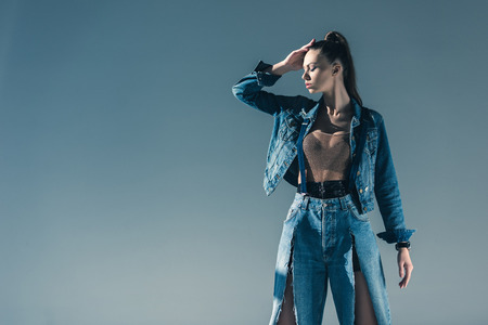 beautiful stylish girl in denim clothes, isolated on greyの写真素材