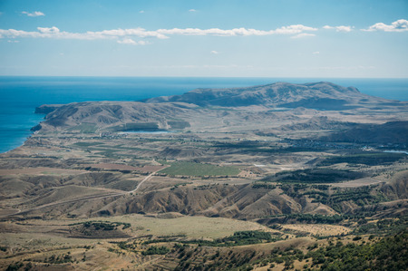 Scenic calm seashore with Crimean mountains ridge, Ukraine, May 2013
