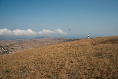 Parachute in the sky over field in hillside area of Crimea, Ukraine, May 2013