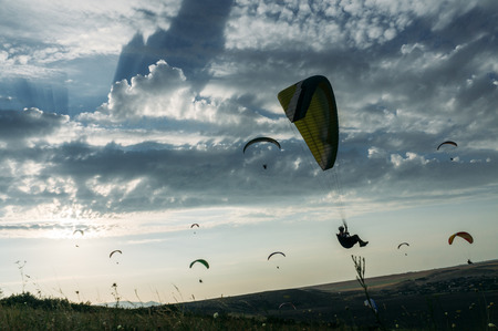 Mountainous landscape with paratroopers flying in the sky, Crimea, Ukraine, May 2013の写真素材