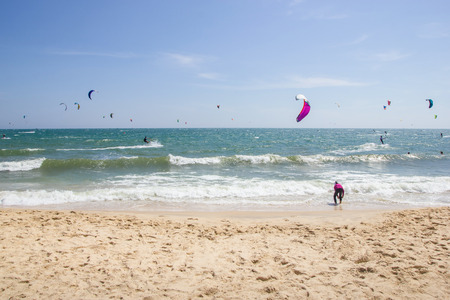 people on paragliders at beautiful sandy seashore, Vietnam, Mui Ne