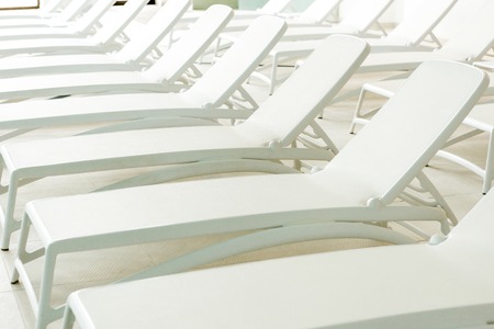 empty white sunbeds in modern spa centerの写真素材