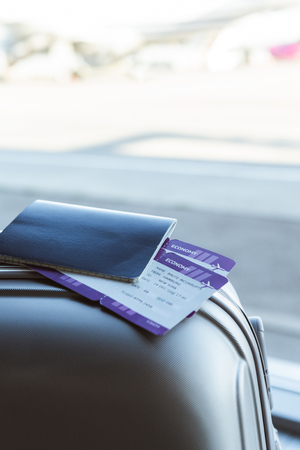 Close up of passport and air tickets on travel bag in airportの写真素材