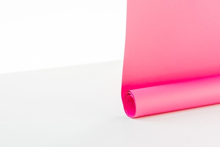 Close up of bright rolled out pink paper hangings on white backgroundの写真素材