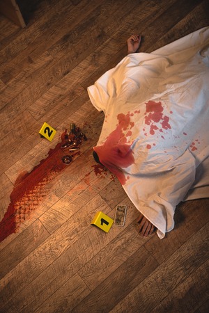 Top view of dead body covered with white sheet at crime sceneの写真素材