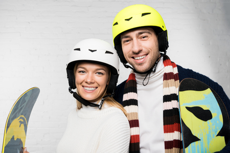 portrait of husband and wife in skiing accessories ready for winter holidayの写真素材