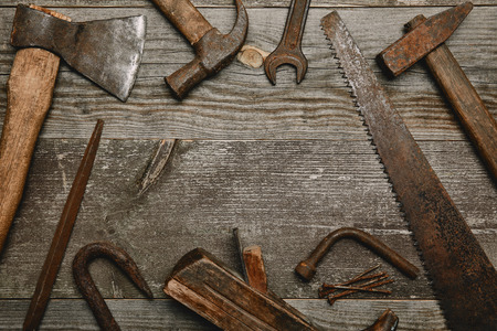 Top view of various tools on wooden background