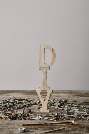Close up of diy sign and nails on wooden table on grey backgroundの写真素材