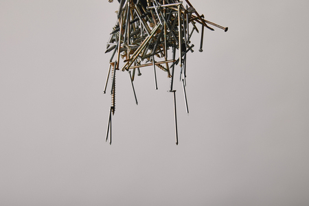Close up of nails and screws tools on grey background