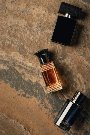 top view of bottled perfumes on brown weathered surfaceの写真素材