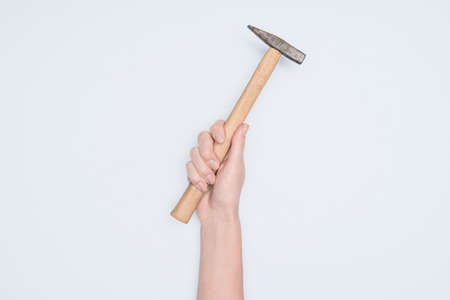 cropped shot of woman holding hammer isolated on whiteの写真素材