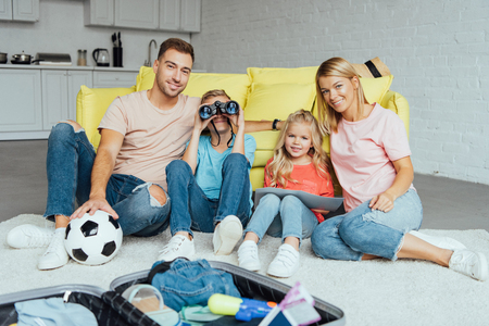 happy family spending great time together while packing for summer vacation, travel conceptの写真素材
