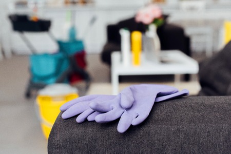 close up of rubber gloves on sofa with blurred background