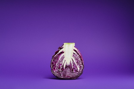close-up view of fresh ripe organic sliced purple cabbage on violet background