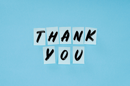 thank you wording on sticky notes isolated on blue backgroundの写真素材