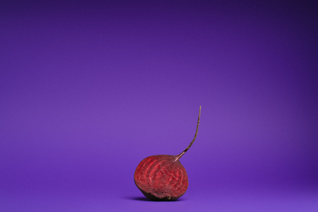 fresh ripe organic halved beetroot on purple background