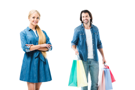 Lovely smiling couple in jeans with shopping bag isolated on whiteの写真素材