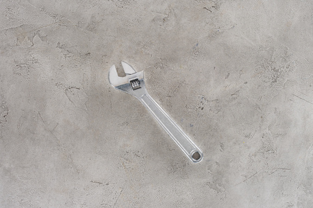 top view of pipe wrench lying on concrete surfaceの写真素材