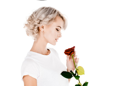 Beautiful woman holding red flower isolated on whiteの写真素材