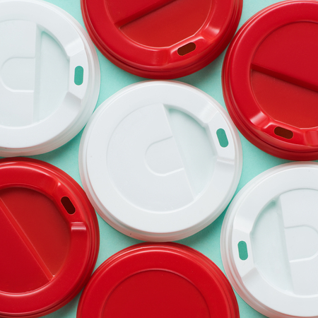 Close up view of red and white lids for drink on blue backgrounの写真素材