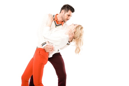Happy attractive couple having fun and dancing isolated on white