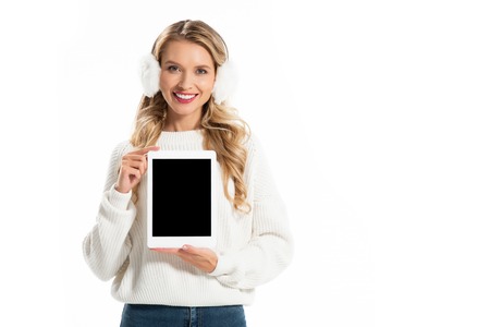 smiling blonde woman presenting digital tablet with blank screen isolated on white