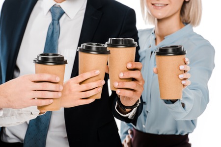 cropped view of businesspeople holding cups with coffee to go isolated on whiteの写真素材