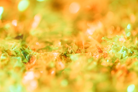 shiny background with orange glitter and bokehの写真素材