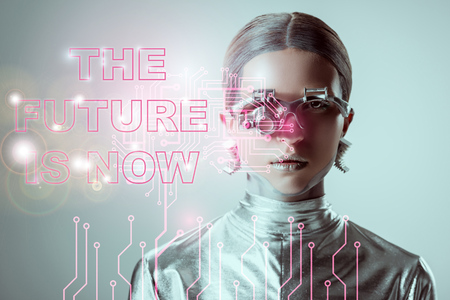 futuristic silver cyborg on grey with "the future is now" lettering and digital dataの写真素材