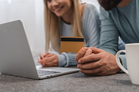 Cropped view of couple with laptop shopping onlineの写真素材