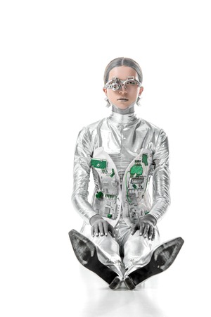 silver robot sitting and looking at camera isolated on white, future technology conceptの写真素材