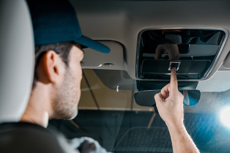 back view of auto mechanic checking automobile detailsの写真素材