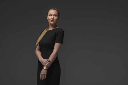 portrait of elegant kazakh woman in black dress posing isolated on greyの写真素材