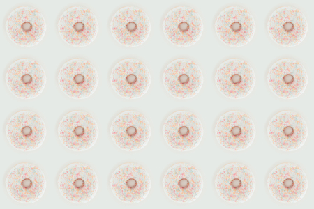 Top view of white glazed doughnuts seamless pattern isolated on white