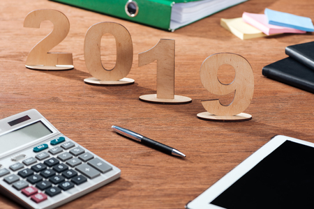 2019 date made of wooden numbers with calculator and stationery on office deskの写真素材