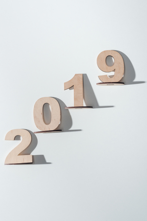 top view of 2019 date made of wooden numbers on white backgroundの写真素材