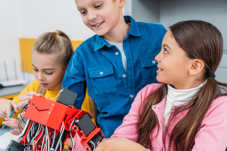 close up view of schoolchildren with handmade electric robot in stem classの写真素材
