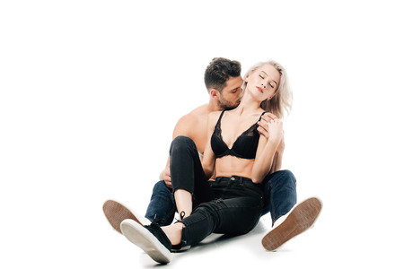 handsome man passionately embracing and kissing woman neck isolated on whiteの写真素材