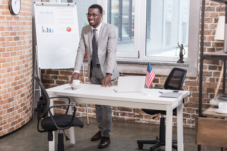 African american businessman standing at office deskの写真素材