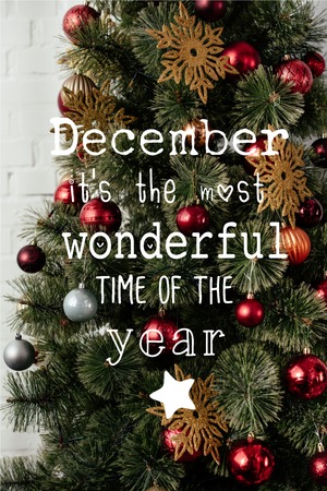 christmas tree with balls and golden snowflakes with "December it is the most wonderful time of the year" letteringの写真素材