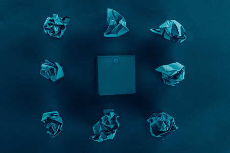 top view of crumpled papers and blank notes on blueの写真素材