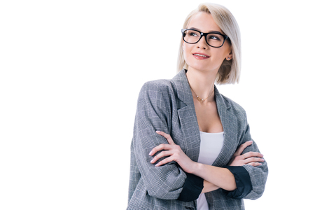 happy businesswoman in eyeglasses with crossed arms, isolated on whiteの写真素材